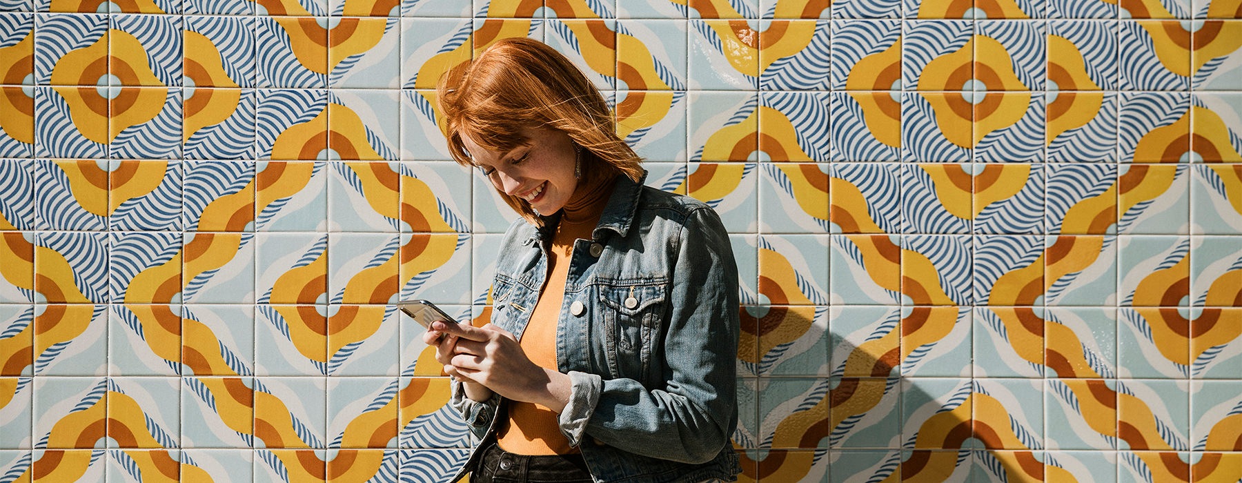 woman in front of wall on phone